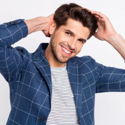 Portrait of charming virile guy fix his haircut touch hairstyle wear blue outfit, blazer jacket isolated over white background